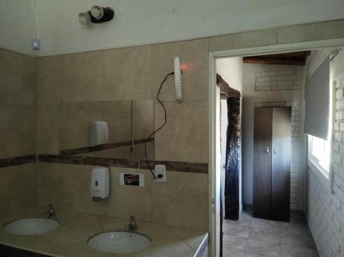a bathroom with two sinks in a room at Finca el gallego in Junín
