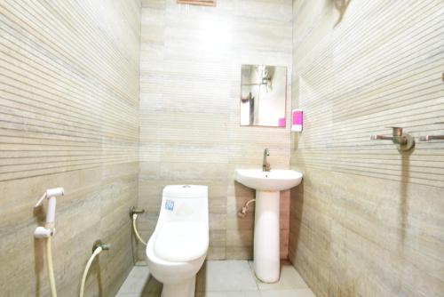 a bathroom with a toilet and a sink at Hotel Stay 21 in Faridabad