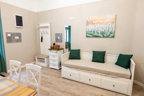 a bedroom with a bed and a table and chairs at Kispolgár Vendégház in Sárospatak