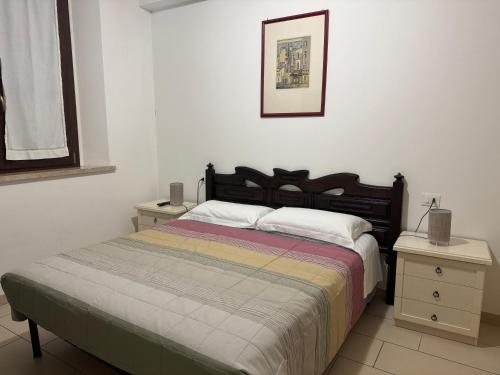 a bedroom with a bed and two night stands at Villa Flavia in Arezzo