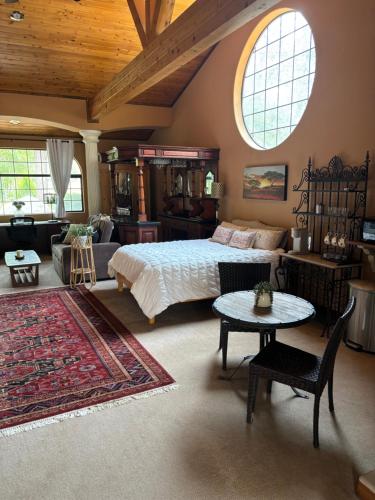 a bedroom with a bed and a living room at Grand Studio with Resort Amenities in Alpine