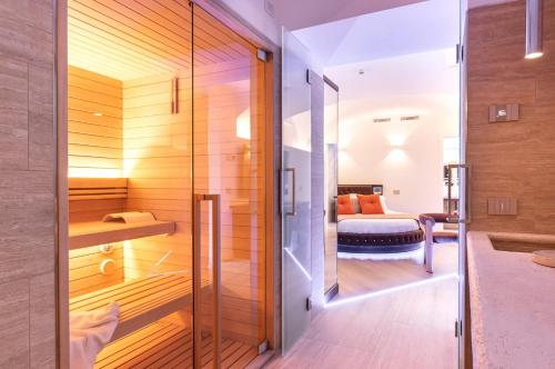 a bathroom with a shower and a bed in a room at Relais V&G in Anagni
