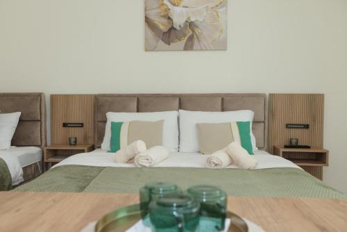 a bedroom with a bed with towels on it at Vila Oaza in Bela Crkva