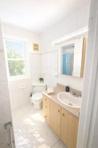a white bathroom with a sink and a toilet at Black door bungalow in Windsor