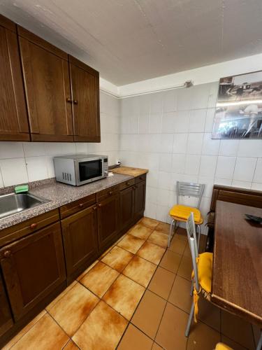 a kitchen with a microwave and a table in it at Giada in Iragna