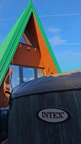 a house with a sign on the front of it at Hot Tub Paradise - Squirrel's House in Žabljak
