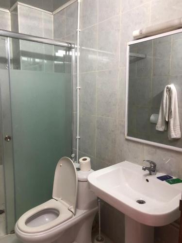 a bathroom with a toilet and a sink and a shower at Hotel El Maghreb in Constantine