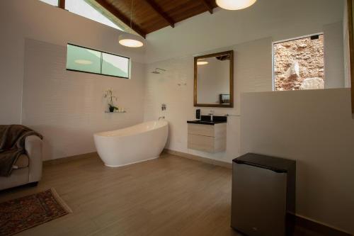a bathroom with a large tub and a sink at Ranch Pachacamac in Pachacamac