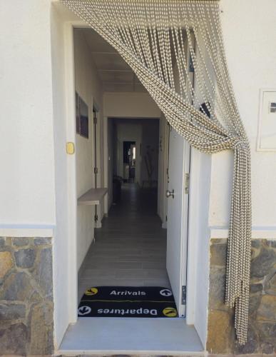 an entrance to a hallway with a curtain over the door at Casa en La Marina cerca de la Playa y Pinada in Elche