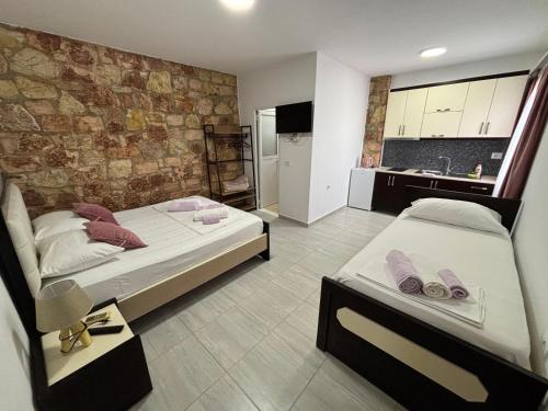 a bedroom with two beds and a kitchen in it at Grand Seaview Apartments in Ksamil