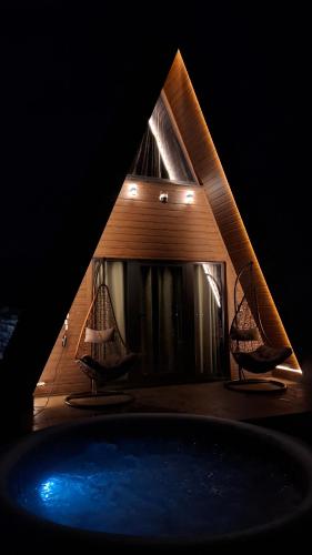 a view of a house with two chairs and a tub at Hot Tub Paradise - Squirrel's House in Žabljak