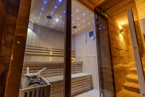 a sauna with a glass door in a room at Palazzo Pisani & Spa Malta in Żabbar