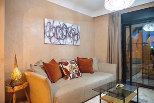 a living room with a couch and a glass table at Palm View in Marrakesh