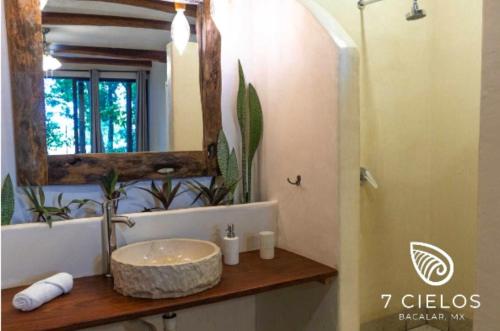a bathroom with a sink and a mirror at 7 CIELOS BACALAR. in Bacalar