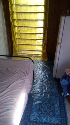 a bed sitting in a room with a window at Mabouya Villas in Dennery