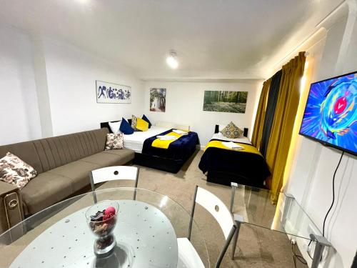 a living room with a couch and a bed at 2 Bedrooms Modern Central London Apartment, Full Kitchen, 5 minutes Tube Station in London