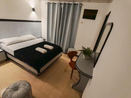 a small bedroom with a bed and a chair at Santa lucia in Panama City