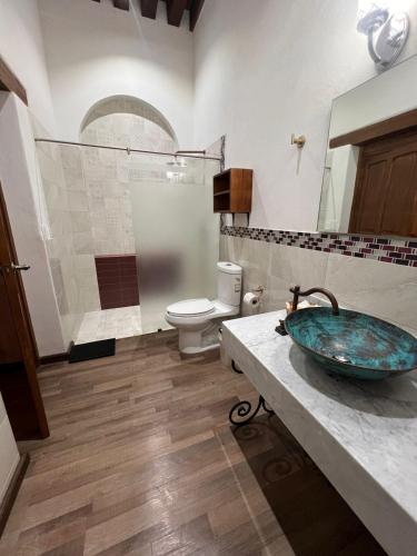 a bathroom with a sink and a toilet at Navarrete 63 Hotel in Morelia