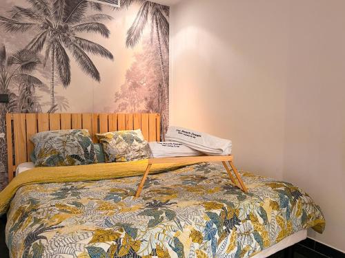 a bedroom with a bed with a wooden head board at The Beach Dream in Saint-Laurent-du-Var