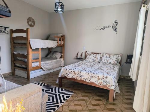 a small room with a bed and a chair at Espaço Meditare in Socorro