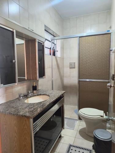 a bathroom with a sink and a toilet and a shower at Espaço Meditare in Socorro