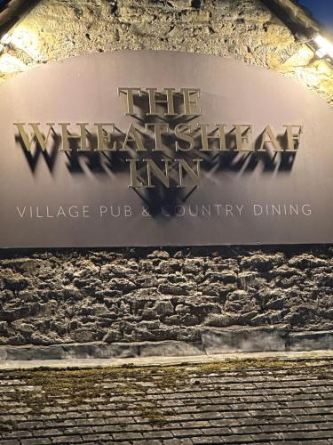a sign for the wichita state inn village pub and country dining at The Hayloft in Oaksey