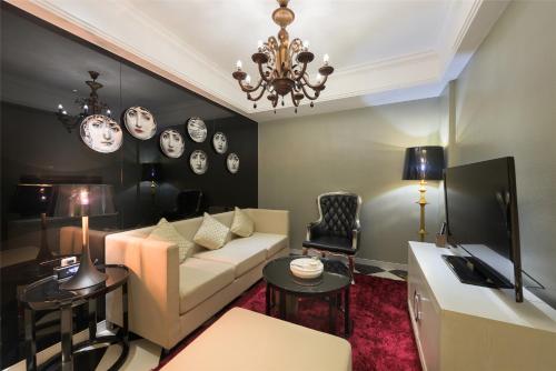 a living room with a couch and clocks on the wall at Mercure Xiamen Exhibition Centre in Xiamen