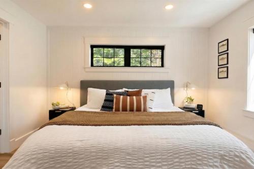 a bedroom with a bed with a window above it at The Kingfisher Lodge in Cornell