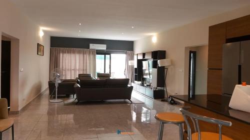 a living room with a couch and a table at villa km22 in Assinie