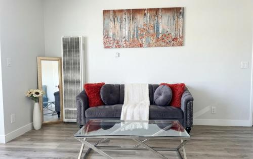 a living room with a couch and a glass table at Hollywood Blvd Prime Location Walk to Attractions with Pool and Free Parking in Los Angeles