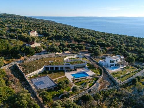 an aerial view of a house with a tennis court at Kai House in Lun