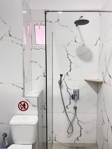 a bathroom with a shower and a toilet at Duka Rooms in Himare