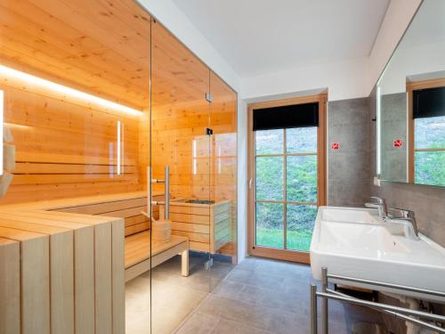 a bathroom with a shower and a sink at Ahorn Mountainlodge in Donnersbachwald