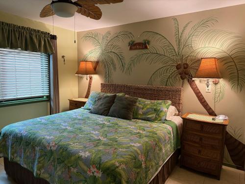 a bedroom with a bed with a plant mural on the wall at Unique Artist Home Steps from the Ocean in Kihei