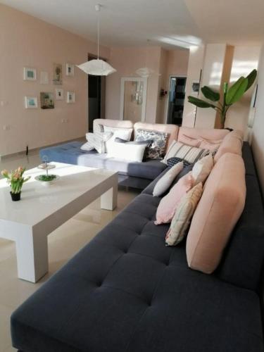 a living room with a couch and a table at Elena's Hotel & apartments in Sarandë