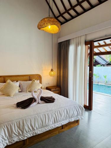 a bedroom with a bed with a towel on it at VILLA Santay byAdiba in Gili Islands