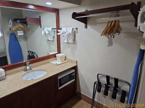 a bathroom with a sink and a mirror at Best Western Montis Inn in Saint Robert