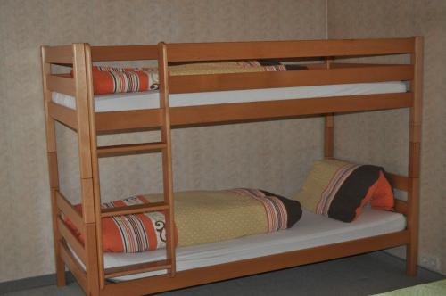 ein Etagenbett aus Holz mit einem kleinen Kind im unteren Etagenbett in der Unterkunft Landhaus Hedy in Heiterwang