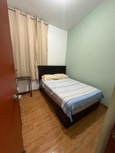 a small bedroom with a bed and a window at Casa Jardín Relax in Moyobamba