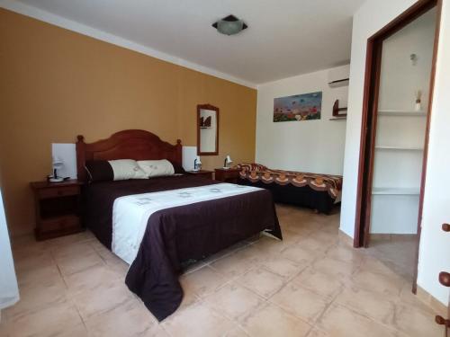 a bedroom with a bed and a couch in it at Departamento CRIMAR in Viedma