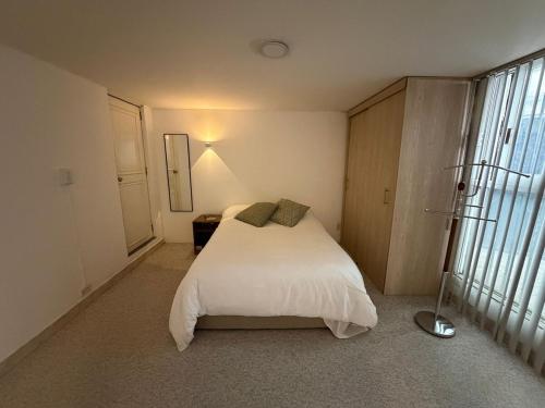 a bedroom with a white bed and a window at Apartment near Azteca Stadium- Coyoacan in Mexico City