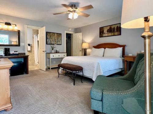 a bedroom with a bed and a couch and a chair at The Mount Vernon Inn in Mount Vernon