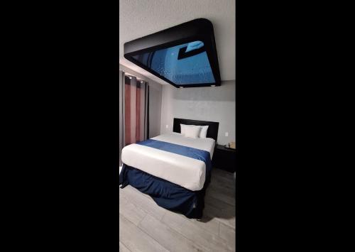 a bedroom with a bed and a flat screen tv at Rainbow Motel in Summit