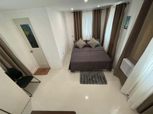 a small bedroom with a bed in a room at Poseidon White Sand Resort & Cave in Santa Rosa