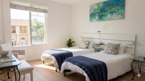 a bedroom with two beds and a window at Hidden Coastal Gem Between Malibu & SB in Oxnard