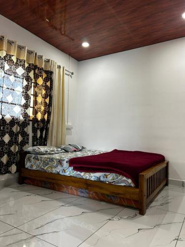 a bed sitting in a room with a wall at brothers holidayas vagamon in Vagamon