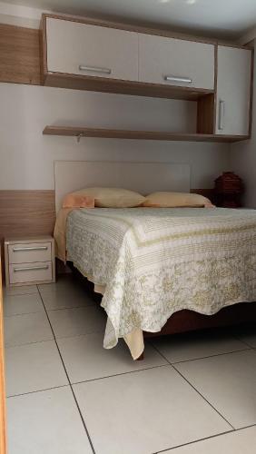 a bedroom with a bed and a white floor at Apê com vista pro Vale dos Vinhedos in Bento Gonçalves