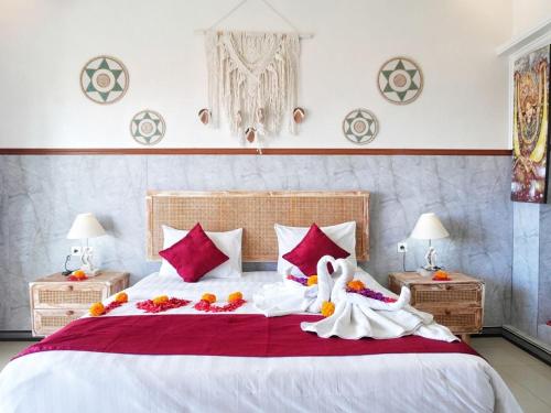 a bedroom with a large bed with flowers on it at Darya Sea View by ABM in Nusa Penida