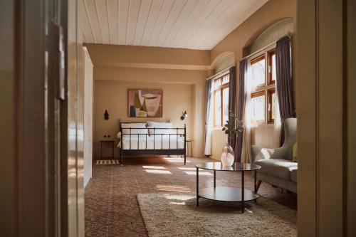 a living room with a bed and a table at Spiegel Home Studio in Semarang