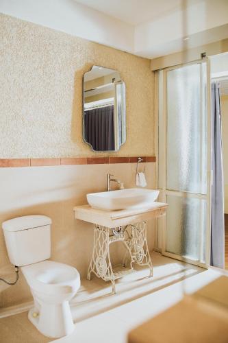 a bathroom with a sink and a toilet at Spiegel Home Studio in Semarang